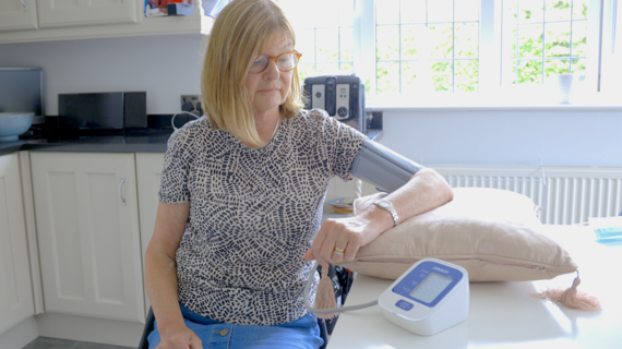 Lady taking blood pressure at home